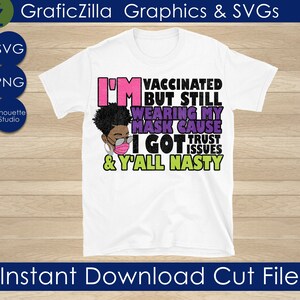May include: A white t-shirt with a graphic design featuring a cartoon woman wearing a face mask. The text on the shirt reads "I'm vaccinated but still wearing my mask cause I got trust issues & y'all nasty".