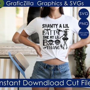 May include: A white t-shirt with a black graphic design that says "Shawty a Lil Batty She My Lil Boo Thang" with a witch and bats.