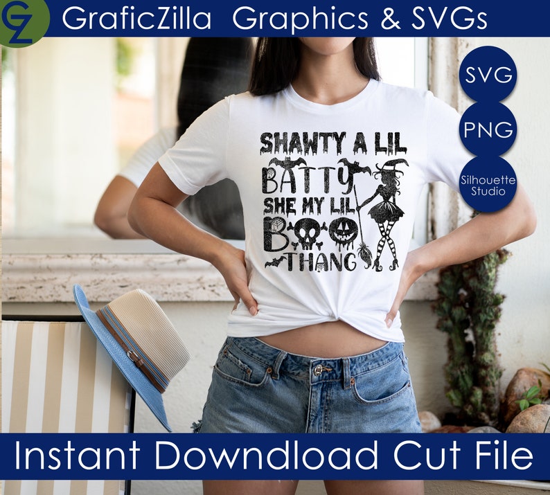 May include: A white t-shirt with a black graphic design that says "Shawty a Lil Batty She My Lil Boo Thang" with a witch and bats.