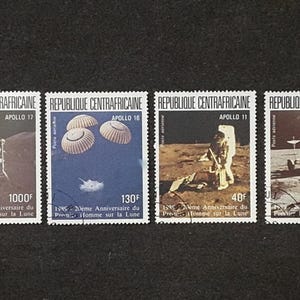 May include: Four postage stamps from the Central African Republic commemorating the Apollo missions. Each stamp features an image of the moon landing, including astronauts and lunar modules. The stamps are in various colors and denominations.