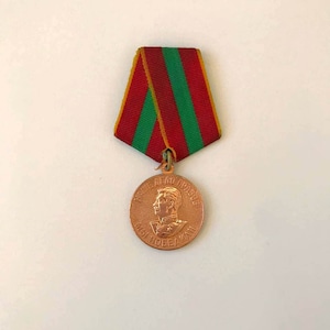 May include: A bronze medal with a red, white, and green ribbon. The medal features a profile of a man in military uniform with the text "ВСЕ ДЛЯ ПОБЕДЫ" around the edge.