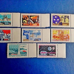 May include: A set of ten vintage Soviet postage stamps featuring colorful illustrations of various industrial and technological advancements. The stamps are in mint condition and have never been used. The stamps are printed in Russian and feature the text "ПОЧТА СССР" (Soviet Post).