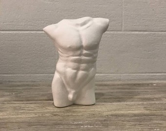 Statue figure of a naked male torso of a body made of sculptural plaster made by hand.Art home decor