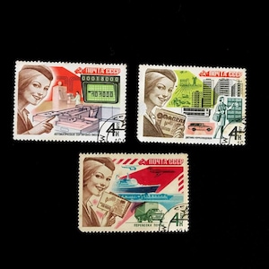 May include: Three vintage Soviet postage stamps with a 4 kopeck denomination. The stamps feature illustrations of women and scenes of transportation and communication technology. The text on the stamps reads "ПОЧТА СССР" which translates to "USSR Post".
