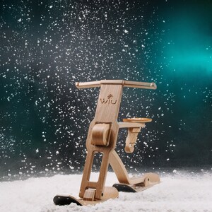 以下が含まれることがあります： 雪景色の中で、Wii Uと書かれた木製のそりが写っています。そりは座席とハンドルが付いています。