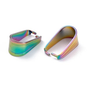 May include: Two iridescent metal pendant bails. The bails are rectangular with a curved top and a small opening at the bottom. The metal has a rainbow finish with hues of purple, green, and gold.