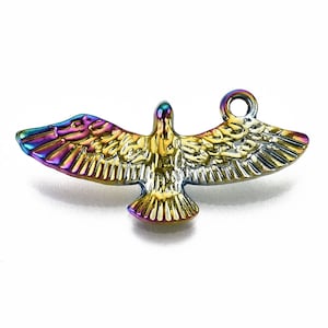 May include: A metal bird charm with outstretched wings, featuring a vibrant iridescent finish. The charm has a loop at the top for easy attachment. The bird's feathers are detailed, and the colors shift from gold to purple and blue.