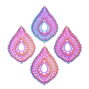 May include: Four iridescent teardrop-shaped pendants with intricate filigree patterns. The pendants transition from pink to purple to blue, with a gold-colored border and a small loop at the top for hanging. These are ideal for jewelry making.