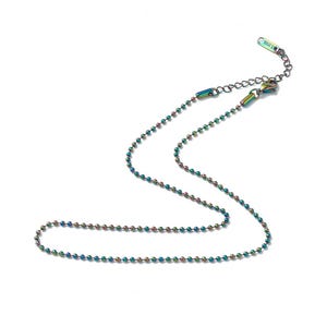May include: A delicate, iridescent ball chain necklace. The necklace features small, evenly spaced beads that shift in color, displaying hues of blue, green, and purple. The chain has an adjustable clasp and is set against a white background.