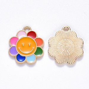 May include: Two gold-colored flower charms with a colorful enamel design. One charm features a smiling face in the center, surrounded by rainbow-colored petals. The other charm has a textured, sunburst pattern on the back.