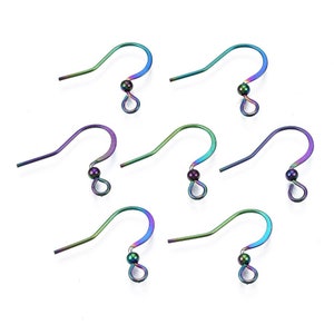May include: Seven iridescent rainbow-colored earring hooks. Each hook has a curved design with a small bead and a loop at the bottom. The hooks display a gradient of colors, including blue, green, and purple.