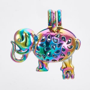 May include: A colorful, iridescent elephant pendant with a unique design. The pendant features a detailed elephant shape with cut-out patterns on its body and three loops at the top for a chain. The elephant's trunk is curled, and it stands on four legs.