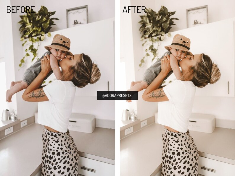 May include: A woman in a white t-shirt and leopard print skirt holds a baby wearing a brown hat with a bear face on it. The baby is wearing a gray shirt and jeans. The woman is kissing the baby on the cheek. The image is taken in a kitchen with white cabinets and a white countertop.