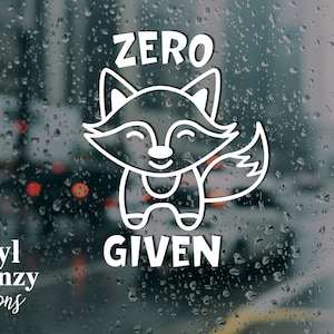 Puede incluir: Calcomanía de vinilo blanco con un zorro de dibujos animados y el texto "ZERO GIVEN".