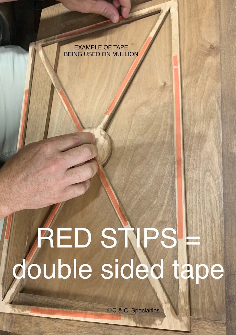 May include: A close-up of a wooden frame with red double-sided tape strips along the edges. The text "EXAMPLE OF TAPE BEING USED ON MULLION" and "RED STIPS = double sided tape" is visible. The text "C & C Specialties" is in the bottom right corner.