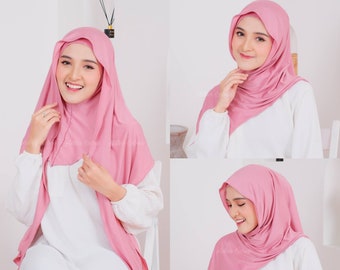 May include: A pink hijab with a simple design. The hijab is made of a soft, stretchy fabric and is easy to style. It is shown in three different ways, with the fabric draped over the shoulders and neck.