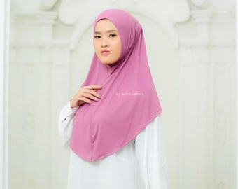 May include: A mauve-colored hijab with a simple design. The hijab is made of a soft, stretchy fabric and has a comfortable fit. The text "by Adha Labels" is printed on the hijab.