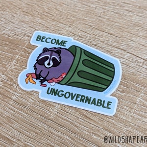 May include: A sticker with a cartoon raccoon in a green trash can. The raccoon is holding a banana peel and the text "Become Ungovernable" is written below the trash can.
