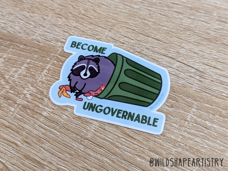 May include: A sticker with a cartoon raccoon in a green trash can. The raccoon is holding a banana peel and the text "Become Ungovernable" is written below the trash can.