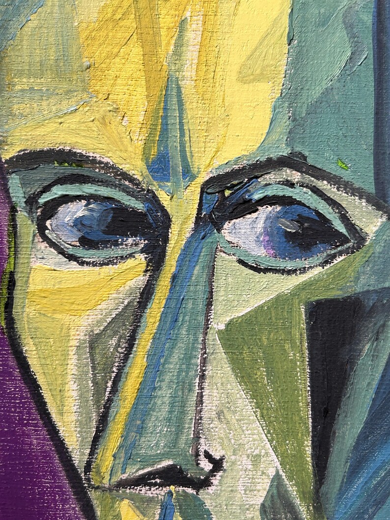May include: A close-up of a painting of a face with blue eyes and a yellow, green, and blue color scheme.