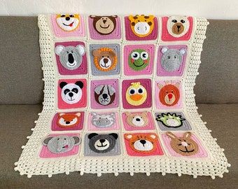 May include: A crocheted baby blanket with a white background and pink squares. Each square features a different animal face, including a lion, panda, elephant, and giraffe.