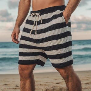 May include: Black and white striped knit shorts with a drawstring waist.