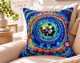 May include: A square pillow cover featuring a vibrant, abstract circular design in shades of blue, teal, orange, and gold. The center displays a mosaic-like pattern of small squares. The text PILLOW COVER ONLY is printed in the upper left corner.