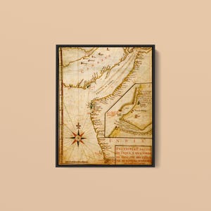 May include: A framed antique nautical map of the Indian coastline featuring a compass rose, intricate hand-drawn cartography, and historical Portuguese text including the title DES CRIPCAO DA COSTA DA INDIA E SEVS PORTOS DE GOA ATE DIO.