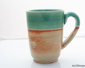 Deep Celadon Green and shades of a sandy brown adorn these lovely mugs that come with a topper to keep your beverage warm