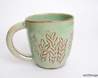 Spring green mug with whimsical carvings