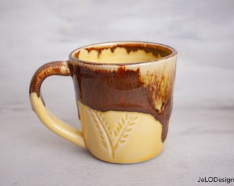 Yellow and copper adorn mugs with handcarvings, great for coffee, tea, cocoa or other beverages.