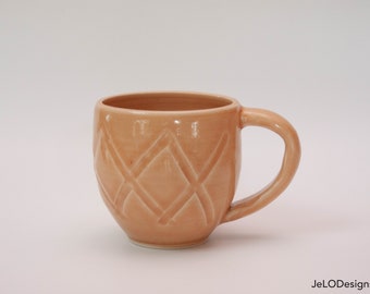 Tangerine covered in hand carvings add texture and make this mug a pleasure to hold, enjoy!