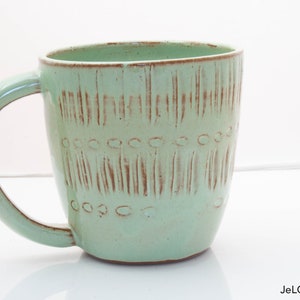 Spring green mug with whimsical carvings image 1