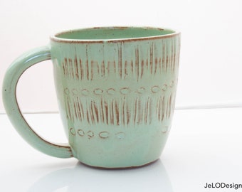 Spring green mug with whimsical carvings