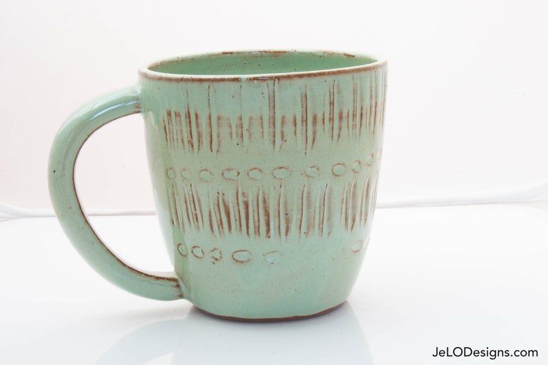 Spring green mug with whimsical carvings image 1