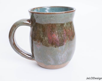 Deep green & copper adorn this rounded mug, inside is spruce green. Great for hot coffee, tea, cocoa or whatever beverages you like to drink