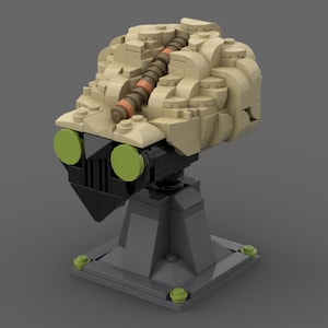 May include: A Lego model of a robot with a beige head, black body, and green eyes. The robot is standing on a gray base.