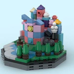 May include: A colorful Lego miniature castle with a pink, blue, and yellow facade, surrounded by green trees and a small blue pond. The castle has a white ice cream cone on top and a yellow roof.