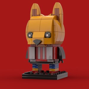 May include: A yellow and red Lego figurine of a fox wearing a striped shirt and standing on a black base.