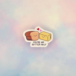 May include: A sticker with a cartoon image of a bread slice and a butter pat, each with a smiling face. The text "You're my butter half" is below the images, with two hearts above. The background is a pastel gradient.