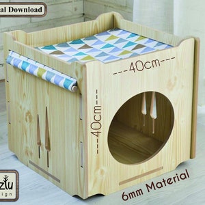 May include: A wooden cat house with a round entrance and a removable cushion. The house is 40 cm wide and 40 cm tall. The house is made of 6 mm thick material.