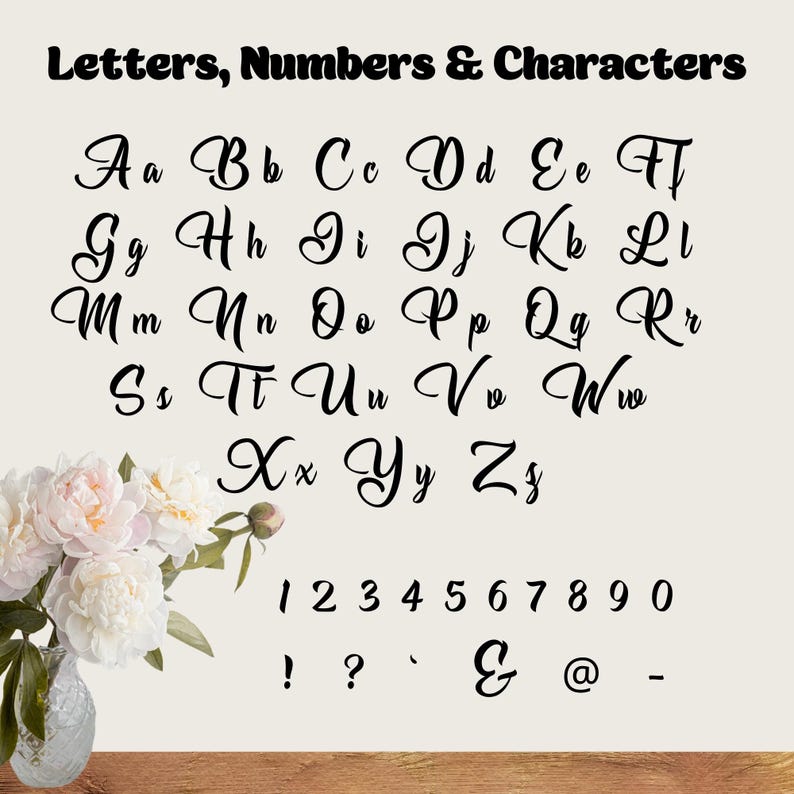 May include: A white background with black cursive letters and numbers. The letters are A through Z and the numbers are 1 through 0. There are also punctuation marks including an exclamation point, question mark, apostrophe, ampersand, at symbol, and hyphen.