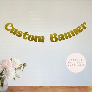 May include: Gold custom banner with the text "Custom Banner" in a retro font. Various colours are available.