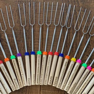May include: A set of 16 wooden marshmallow sticks with colourful tips and personalised names. The sticks are ideal for toasting marshmallows over a campfire or at a bonfire.