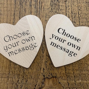 May include: Two wooden heart-shaped ornaments with the text "Choose your own message" on each.