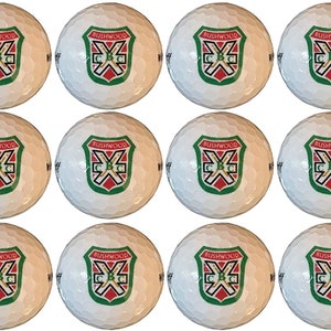May include: Twelve white golf balls with a green, red, and gold logo that says "Bushwood C.C."