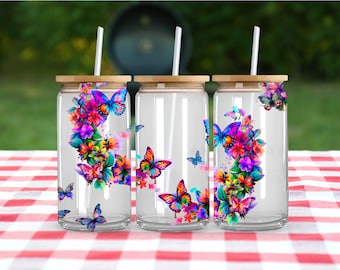 May include: Three clear glass tumblers with bamboo lids and straws. Each tumbler features a colourful butterfly and floral design.