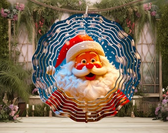 May include: A metal wind spinner featuring a cartoon Santa Claus with a red hat and white beard against a blue background with white snowflakes. The spinner has a layered design with wavy lines.