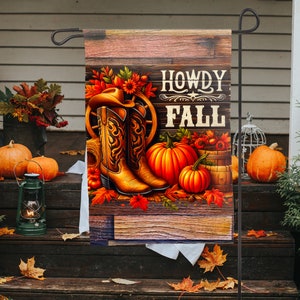 May include: A rustic wooden sign with the text "Howdy Fall" in a brown and white font. The sign is decorated with cowboy boots, pumpkins, and fall leaves.