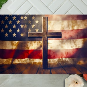 Peut inclure: Une croix en bois se dresse devant un drapeau am&eacute;ricain d&eacute;lav&eacute;. Le drapeau est drap&eacute; sur une surface en bois. La croix est brune et a un aspect vieilli.